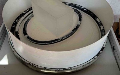 Glass sculpture being polished with cerium oxide for a high-gloss optical finish.